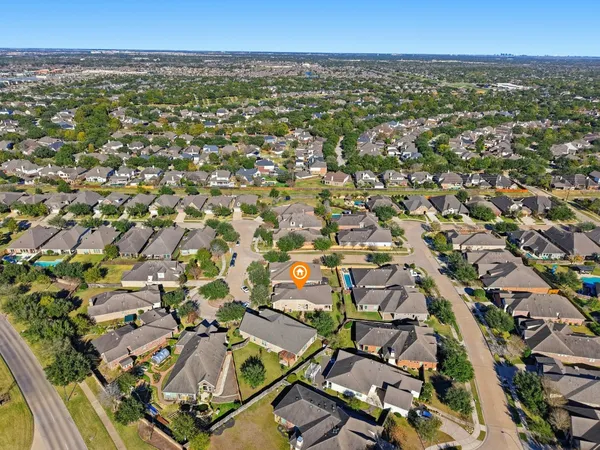 an aerial view of residential houses with outdoor space