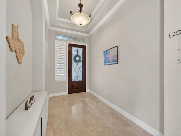 an empty room with windows and cabinet