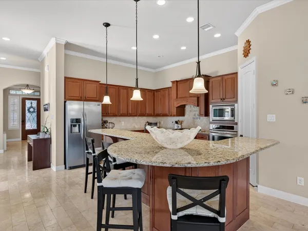 a kitchen with a table chairs refrigerator and microwave