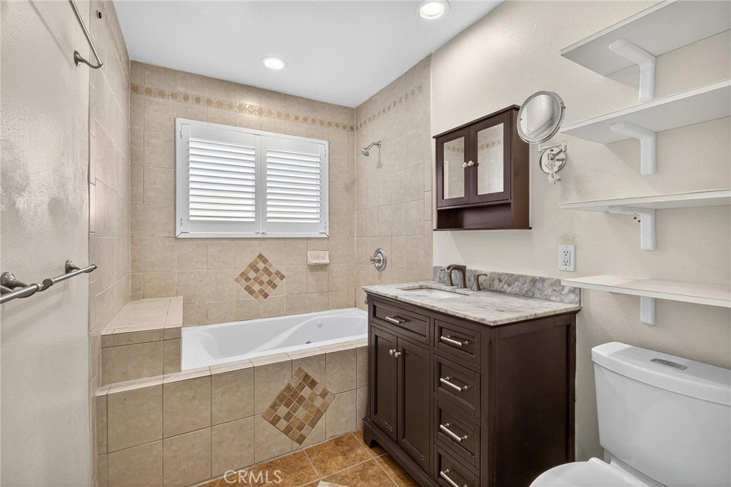 2519 Ralston Lane Redondo Beach, CA 90278 - Photo 21 of 69 a bathroom with a granite countertop sink a toilet a mirror and bathtub