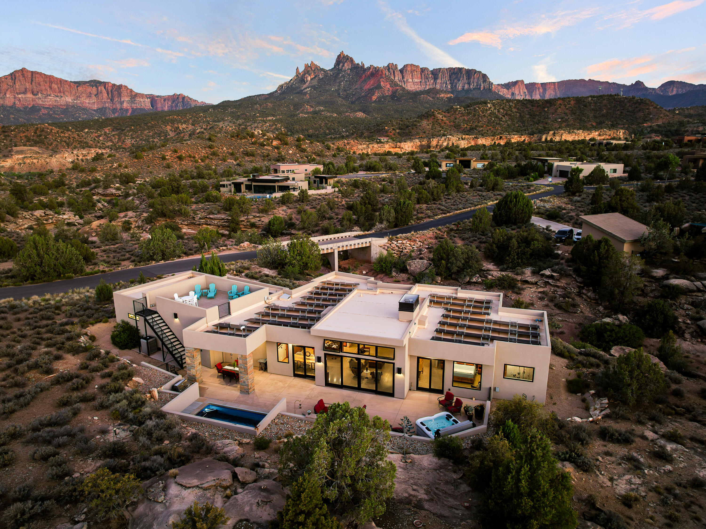 3000 Navajo Way Springdale, UT 84767 - Photo 55 of 63 Golden-hour aerial showing the home, rear patio, and swim spa within its 0.77-acre lot.