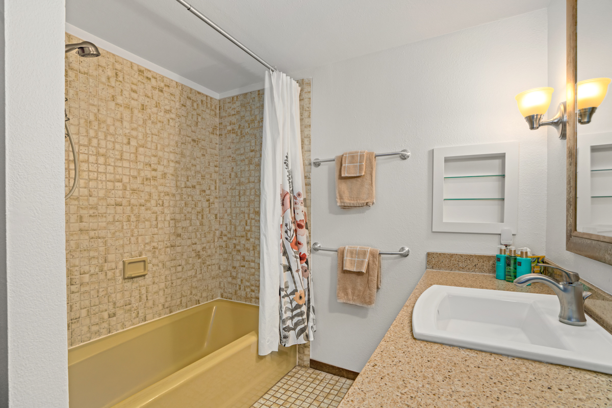 1870 Hoone Road, Unit 602 Koloa, HI 96756 - Photo 21 of 26 a bathroom with a bathtub and a shower
