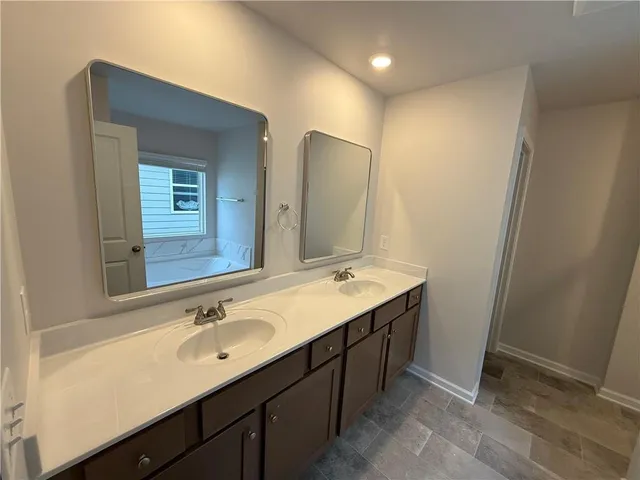 a bathroom with a double vanity sink and a mirror