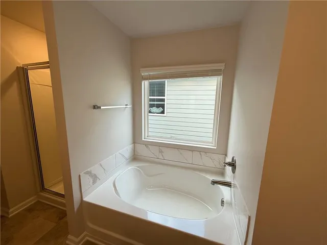a bathroom with a tub and a sink