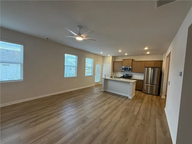 a kitchen with a refrigerator and a sink