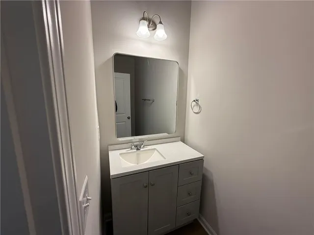 a bathroom with a sink vanity and mirror