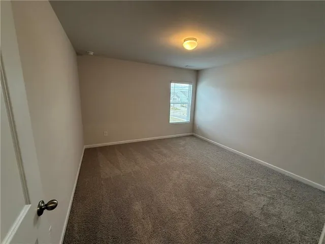 an empty room with windows and entrance