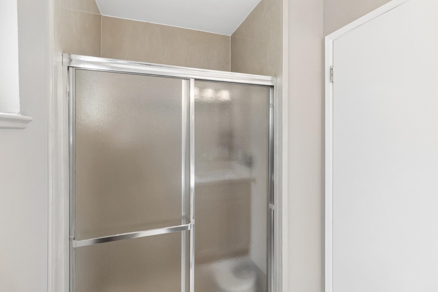 7249 Windjammer Way Citrus Heights, CA 95621 - Photo 25 of 41 a bathroom with a glass shower door