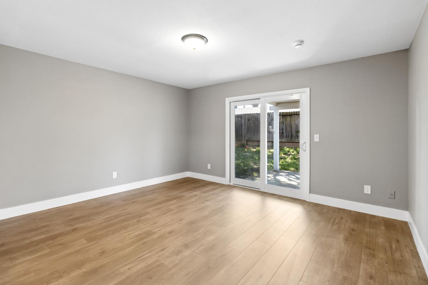7249 Windjammer Way Citrus Heights, CA 95621 - Photo 28 of 41 a view of an empty room with wooden floor and a window