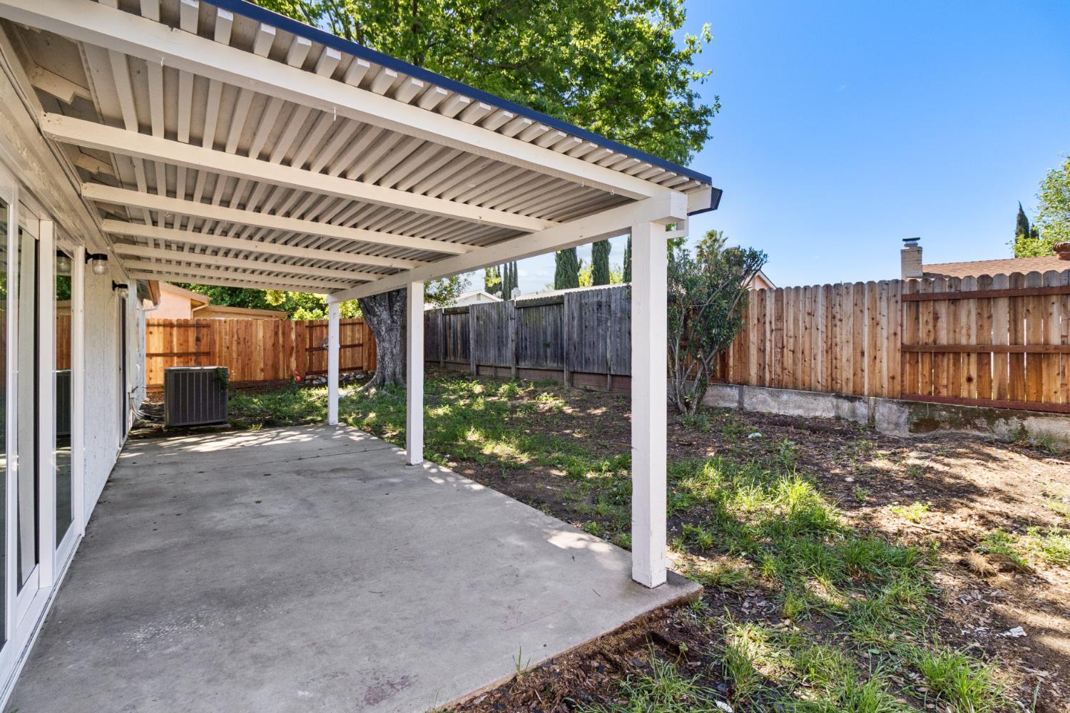 7249 Windjammer Way Citrus Heights, CA 95621 - Photo 37 of 41 a view of a patio with table and chairs a barbeque with wooden fence