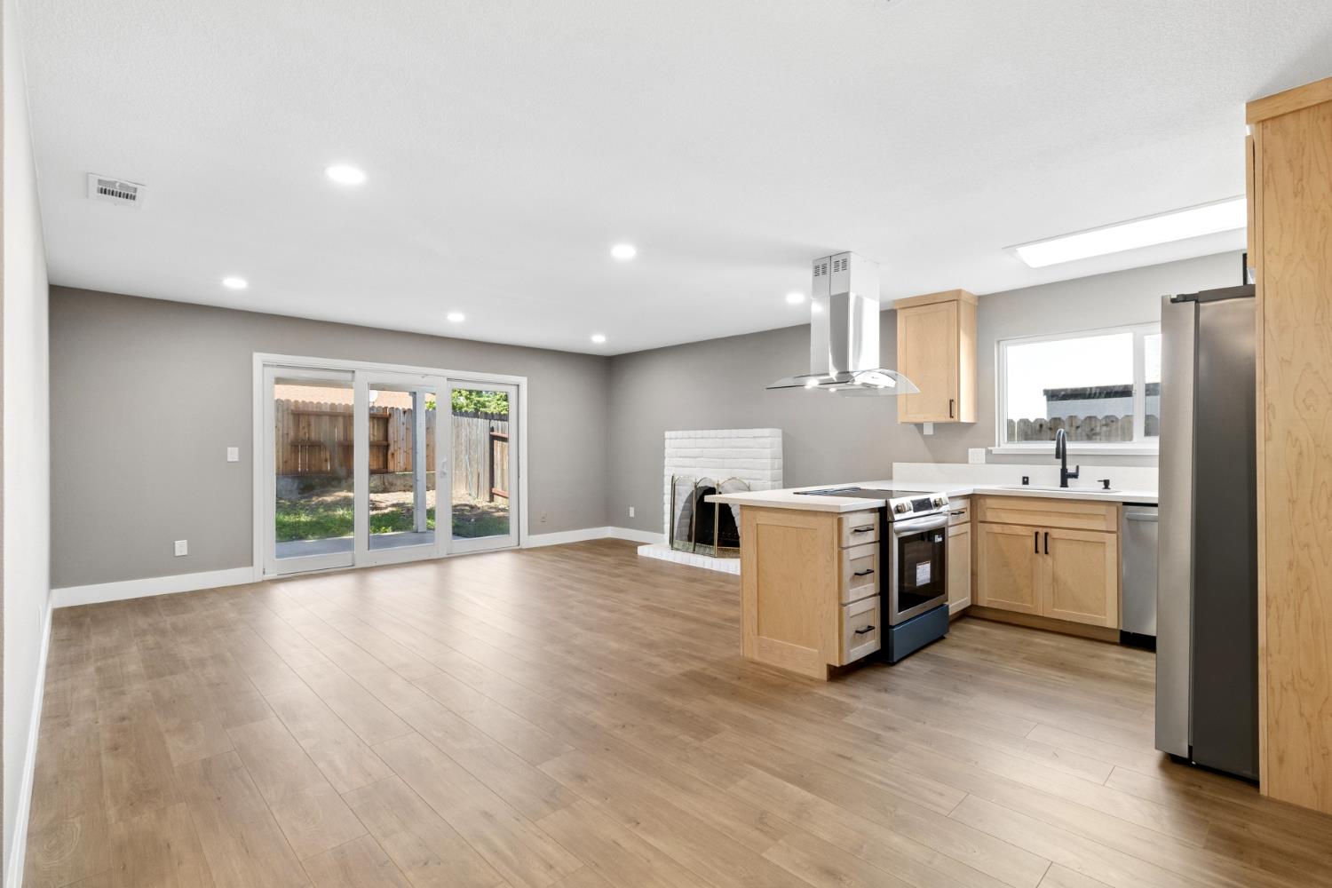 7249 Windjammer Way Citrus Heights, CA 95621 - Photo 4 of 41 a large kitchen with a wooden floor and a large window