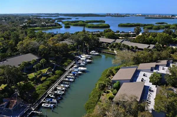 an aerial view of lake with residential houses with outdoor space