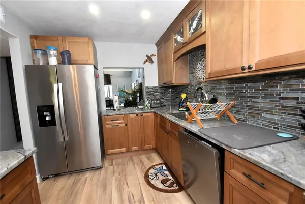 a kitchen with stainless steel appliances a sink a stove and a refrigerator