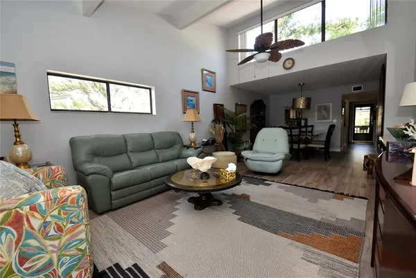 a living room with furniture and a chandelier