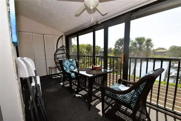 a view of a balcony with chairs and wooden floor