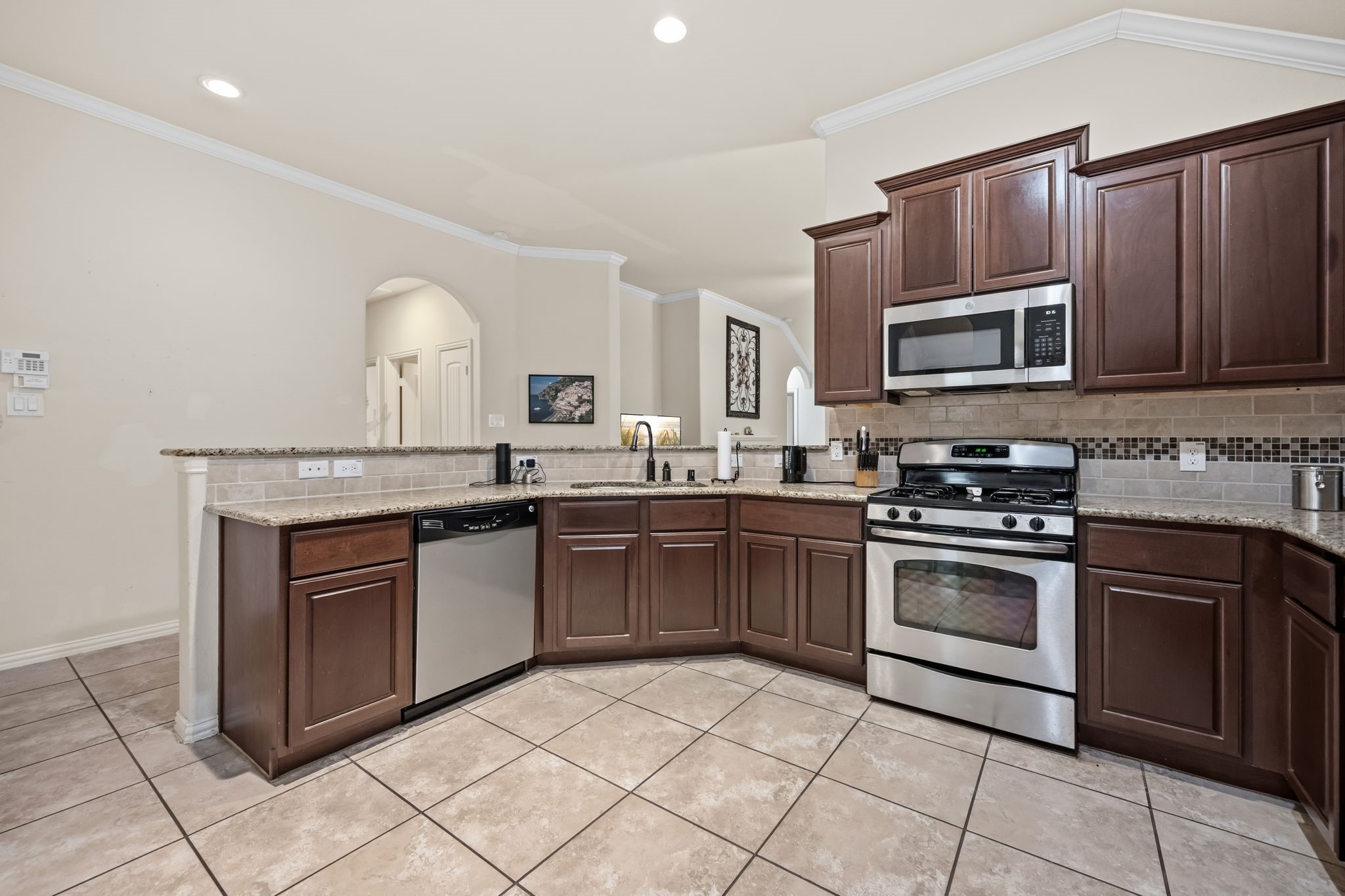 24118 McKinzie Ridge Drive Porter, TX 77365 - Photo 12 of 25 a kitchen with stainless steel appliances granite countertop a stove microwave and cabinets