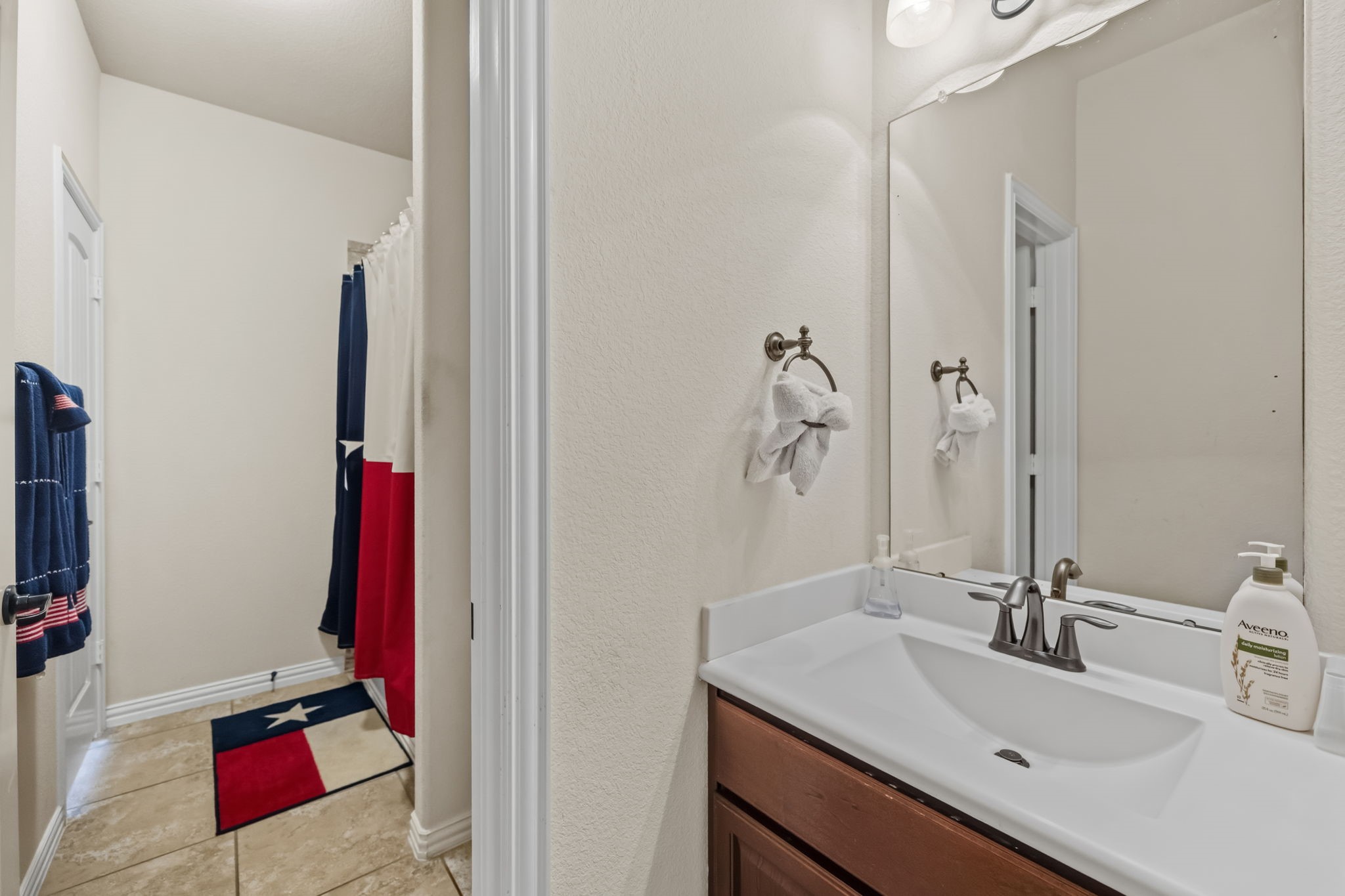 24118 McKinzie Ridge Drive Porter, TX 77365 - Photo 15 of 25 a bathroom with a sink and a mirror