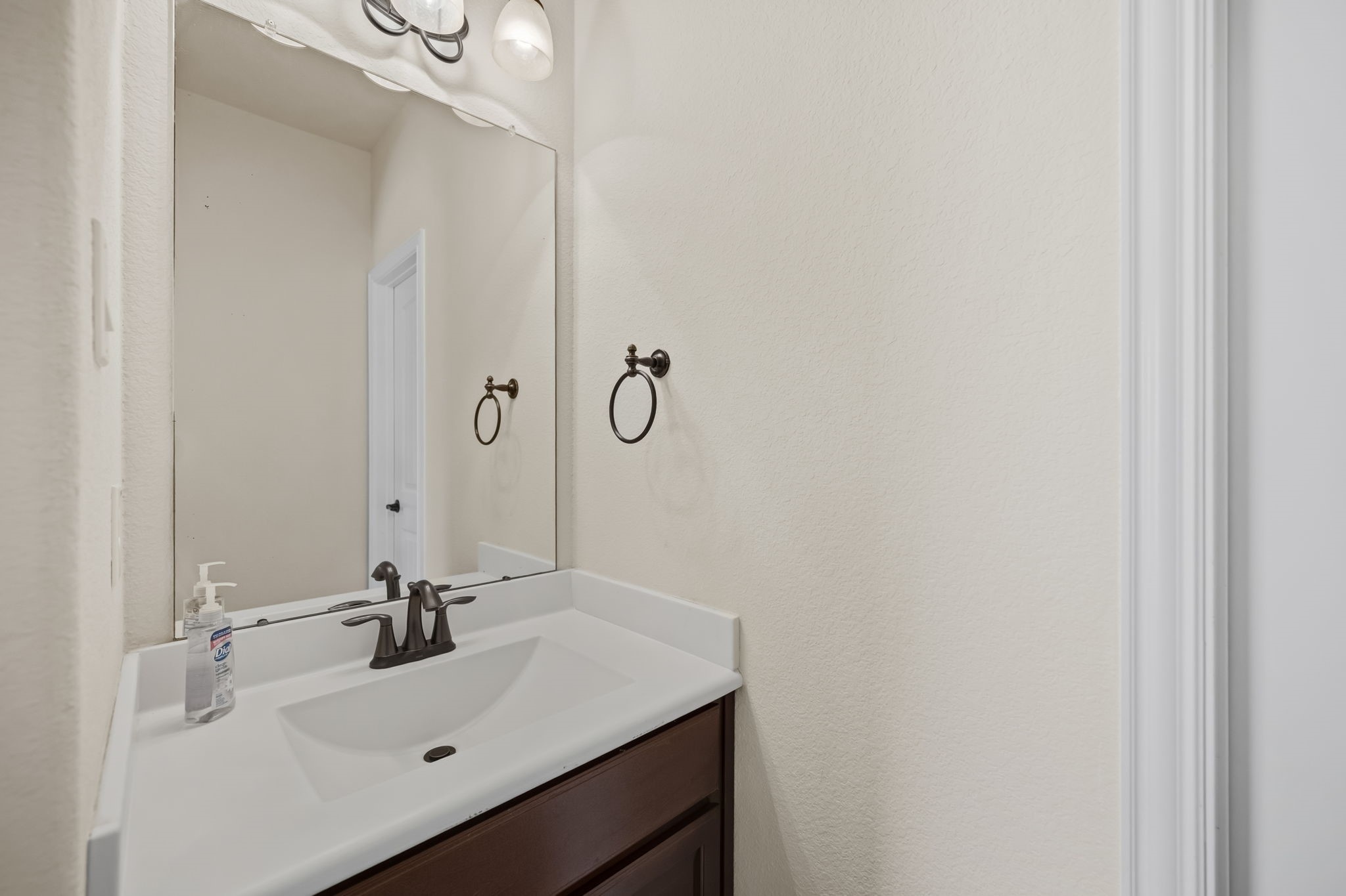 24118 McKinzie Ridge Drive Porter, TX 77365 - Photo 16 of 25 a bathroom with a sink and a mirror