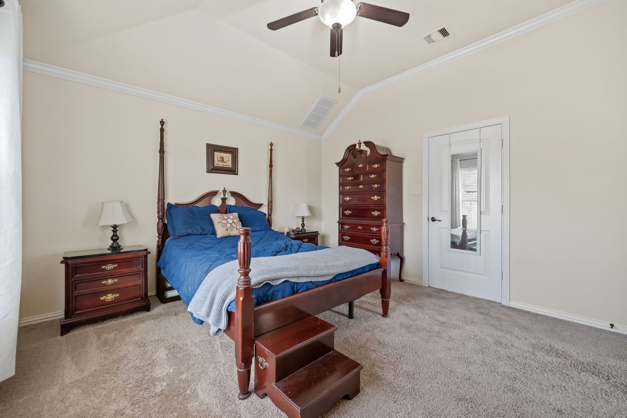 24118 McKinzie Ridge Drive Porter, TX 77365 - Photo 19 of 25 a bed room with a bed and a chandelier