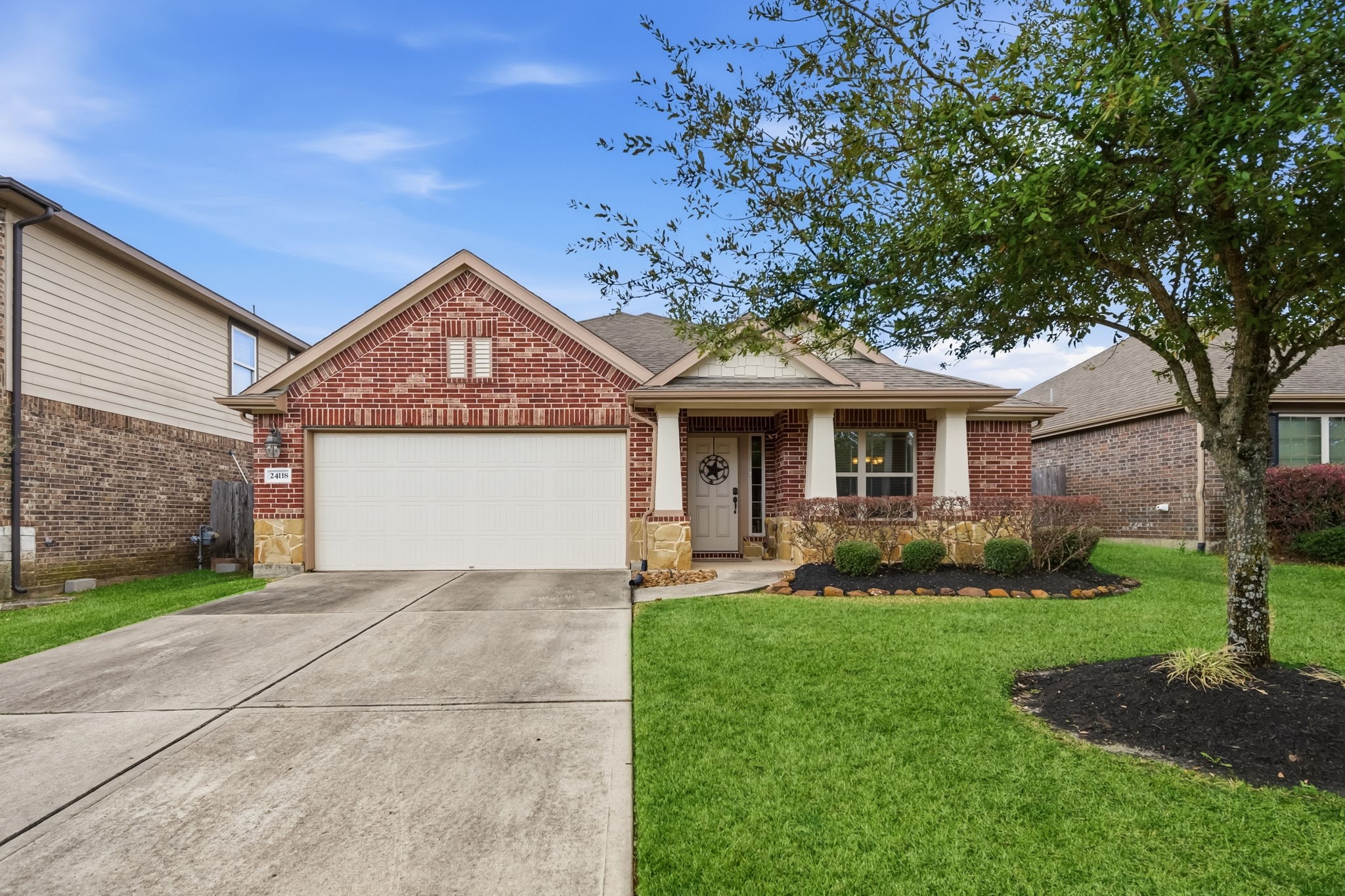 24118 McKinzie Ridge Drive Porter, TX 77365 - Photo 2 of 25 a front view of a house with a yard and garage