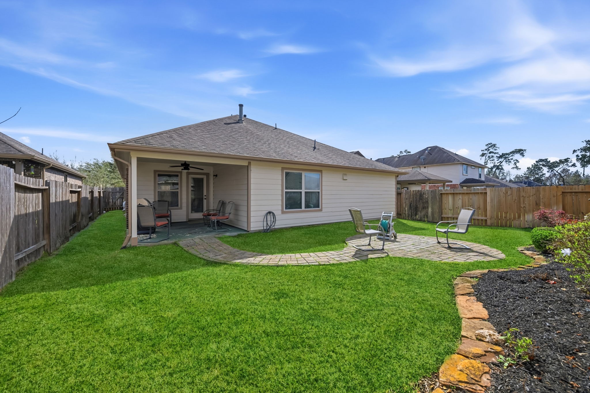 24118 McKinzie Ridge Drive Porter, TX 77365 - Photo 22 of 25 a view of a house with a yard and sitting area