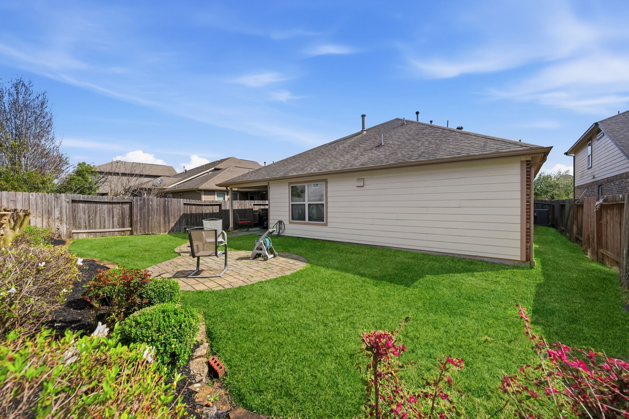24118 McKinzie Ridge Drive Porter, TX 77365 - Photo 23 of 25 a view of a house with backyard sitting area and garden