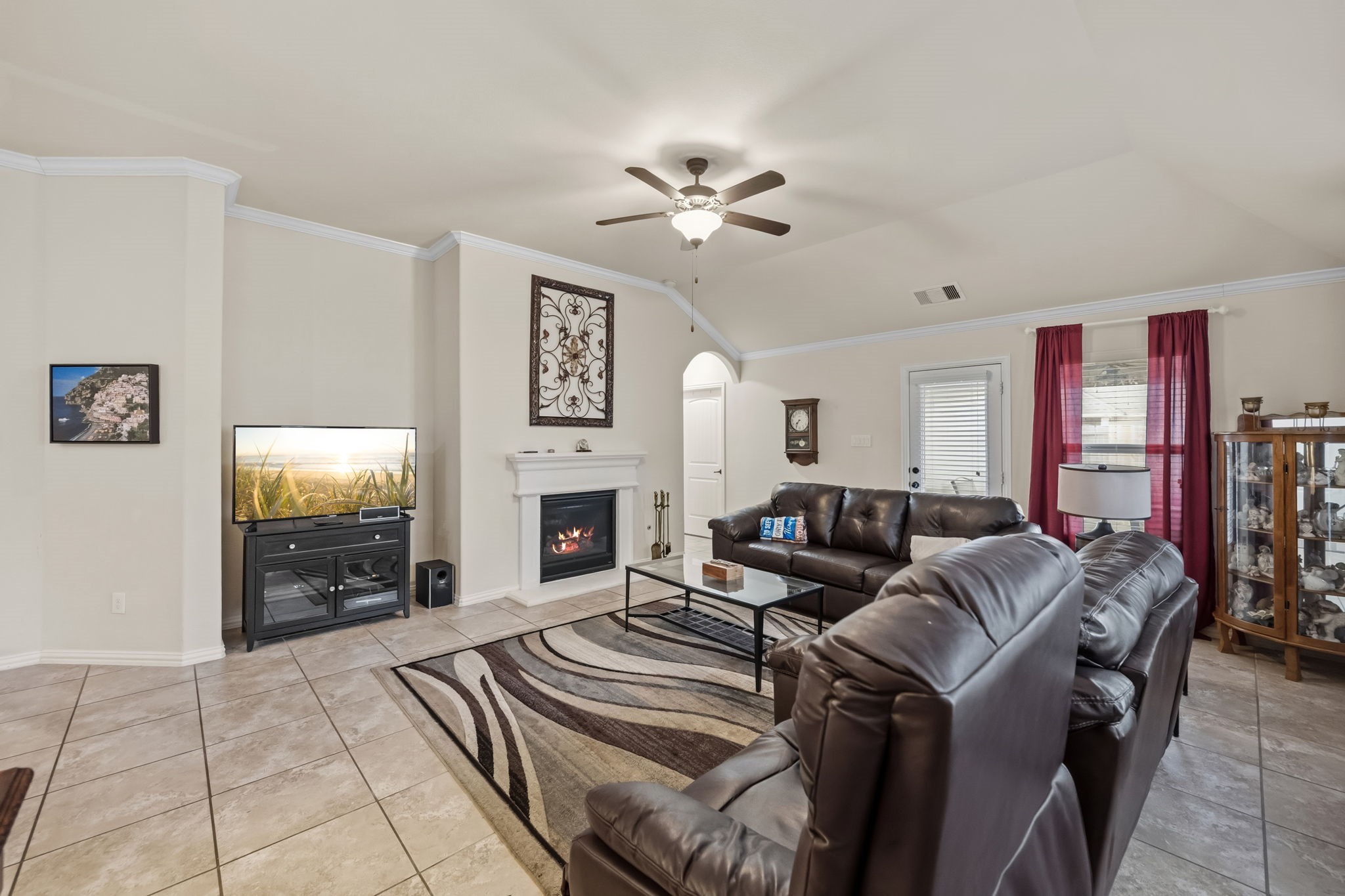 24118 McKinzie Ridge Drive Porter, TX 77365 - Photo 6 of 25 a living room with furniture a fireplace and a flat screen tv