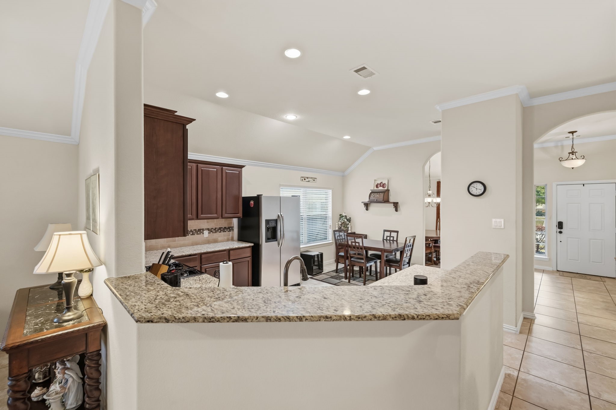 24118 McKinzie Ridge Drive Porter, TX 77365 - Photo 9 of 25 a kitchen with stainless steel appliances granite countertop a sink and a refrigerator
