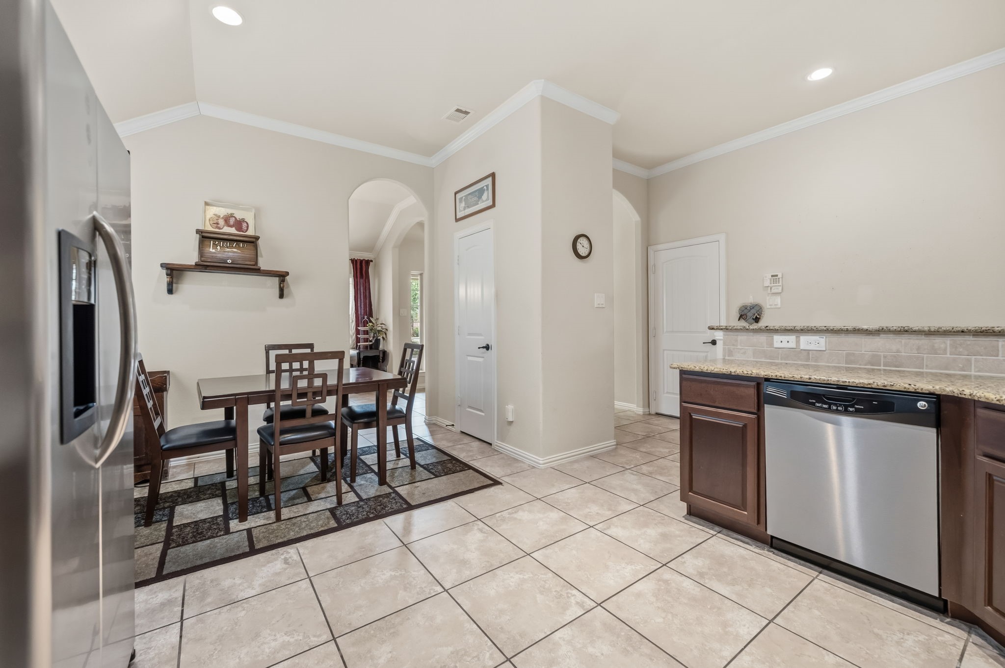 24118 McKinzie Ridge Drive Porter, TX 77365 - Photo 10 of 25 a kitchen with stainless steel appliances granite countertop a refrigerator and a stove top oven