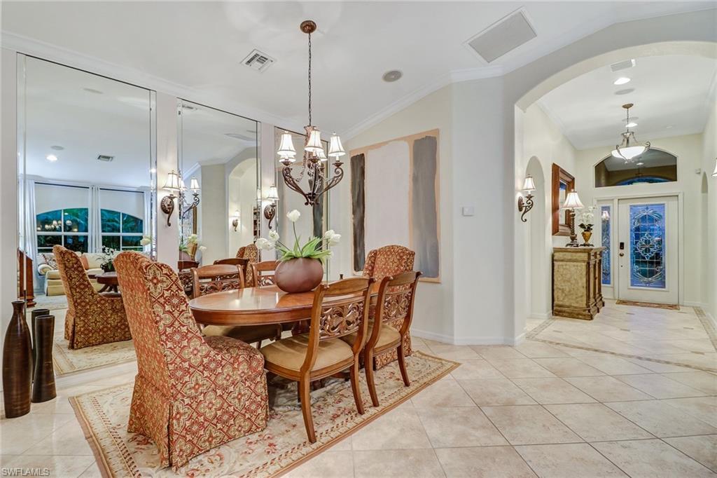 19731 Villa Rosa Loop Estero, FL 33967 - Photo 11 of 27 a dining room with furniture a chandelier and wooden floor