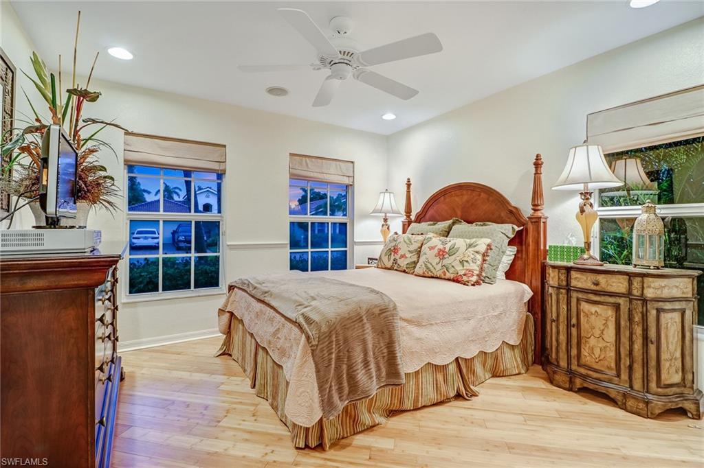 19731 Villa Rosa Loop Estero, FL 33967 - Photo 14 of 27 a bedroom with a large bed and a dresser
