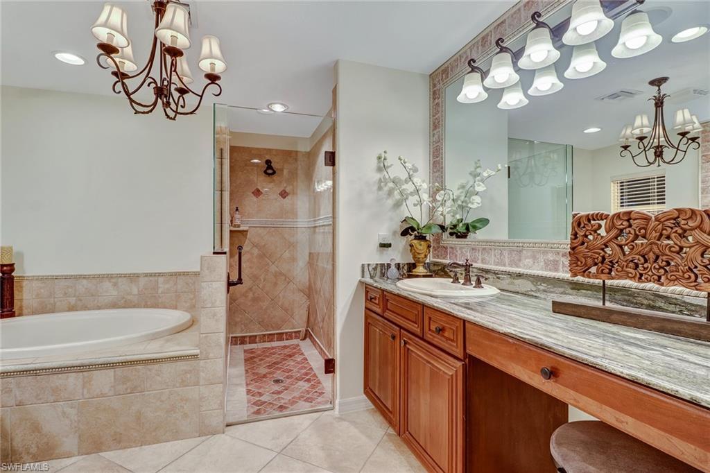 19731 Villa Rosa Loop Estero, FL 33967 - Photo 17 of 27 a spacious bathroom with a tub sink and mirror