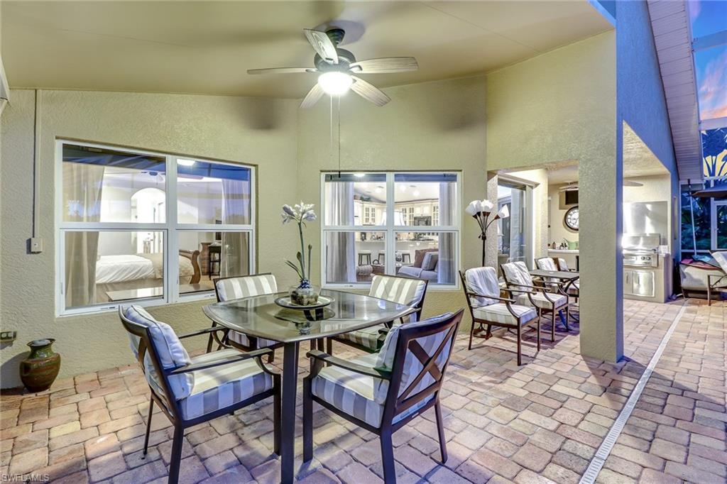19731 Villa Rosa Loop Estero, FL 33967 - Photo 21 of 27 a dining room with furniture a chandelier and a rug