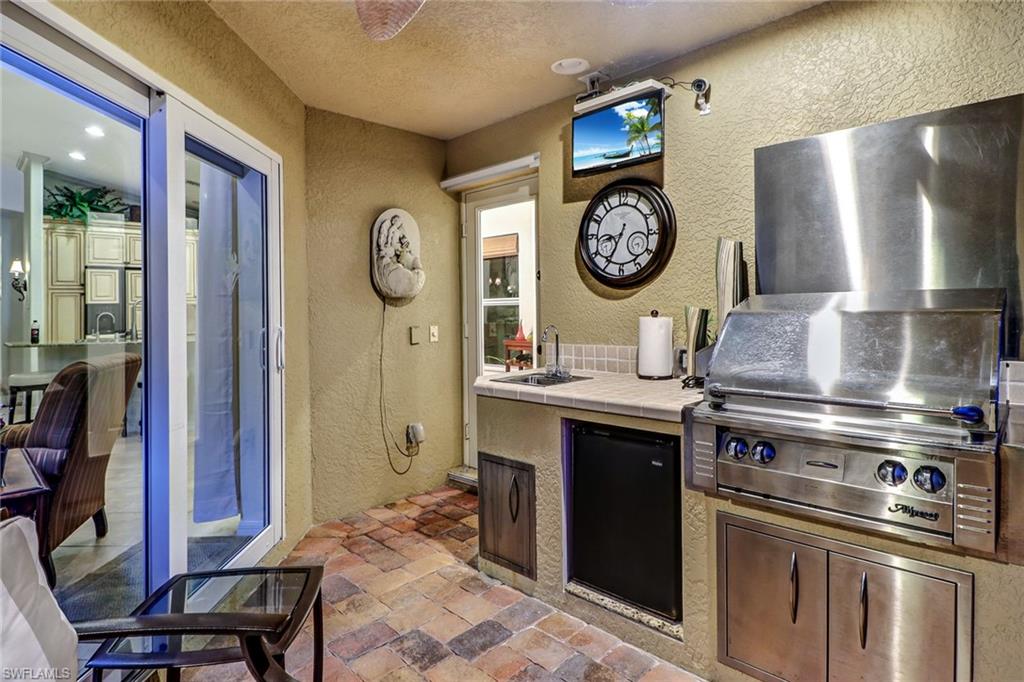 19731 Villa Rosa Loop Estero, FL 33967 - Photo 22 of 27 a kitchen with a stove and a clock
