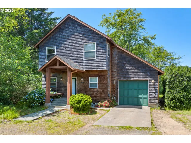 a view of a house with a yard and potted plants
