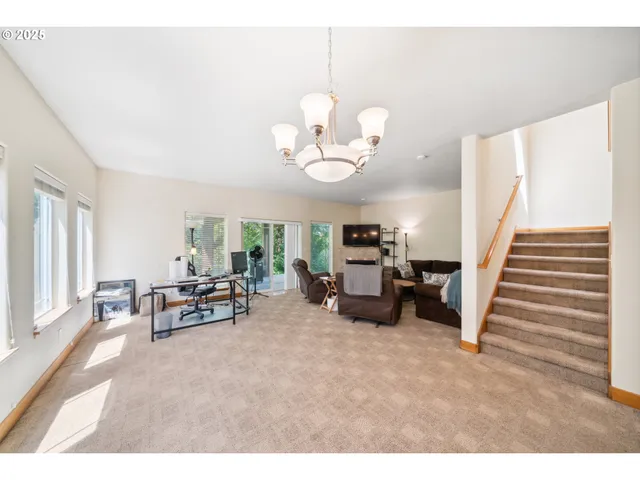 a view of living room with furniture and a chandelier