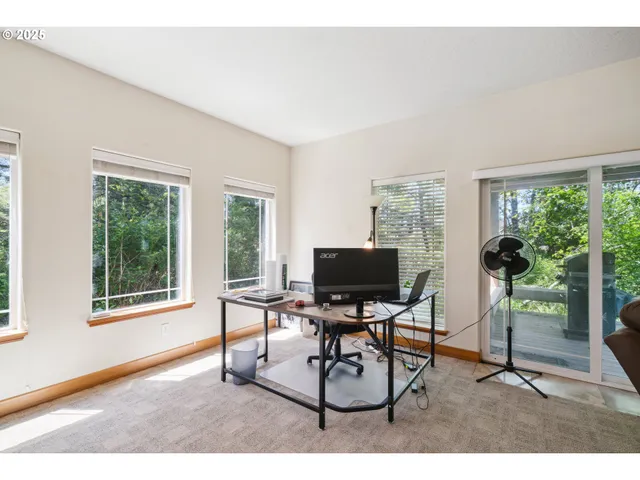 a living room with furniture a window and a flat screen tv
