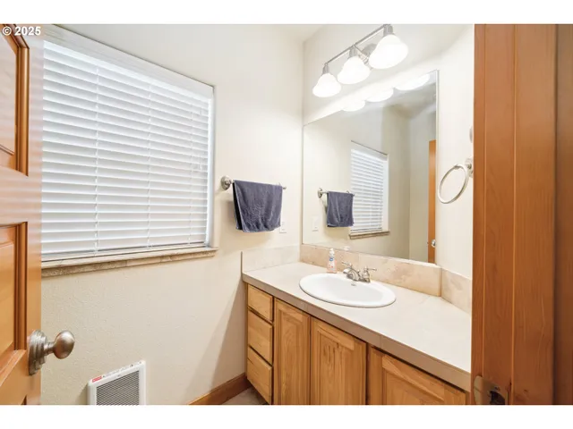 a bathroom with a sink a vanity and a mirror