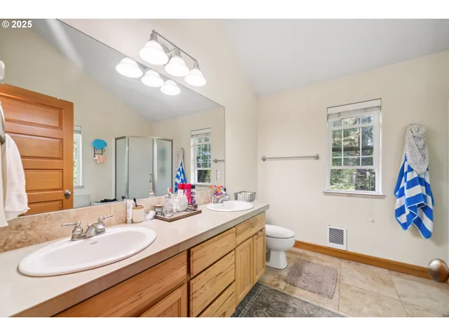 a bathroom with a sink vanity granite and toilet
