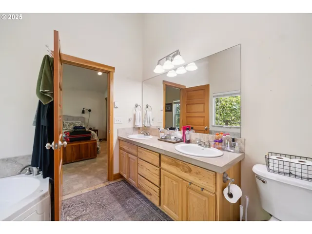 a en suite bathroom with a sink double vanity and a mirror