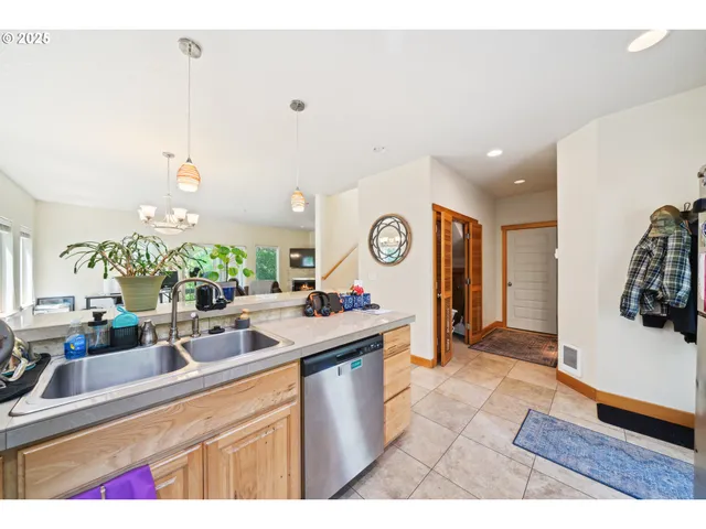 a kitchen that has a lot of cabinets a sink and a wooden floor
