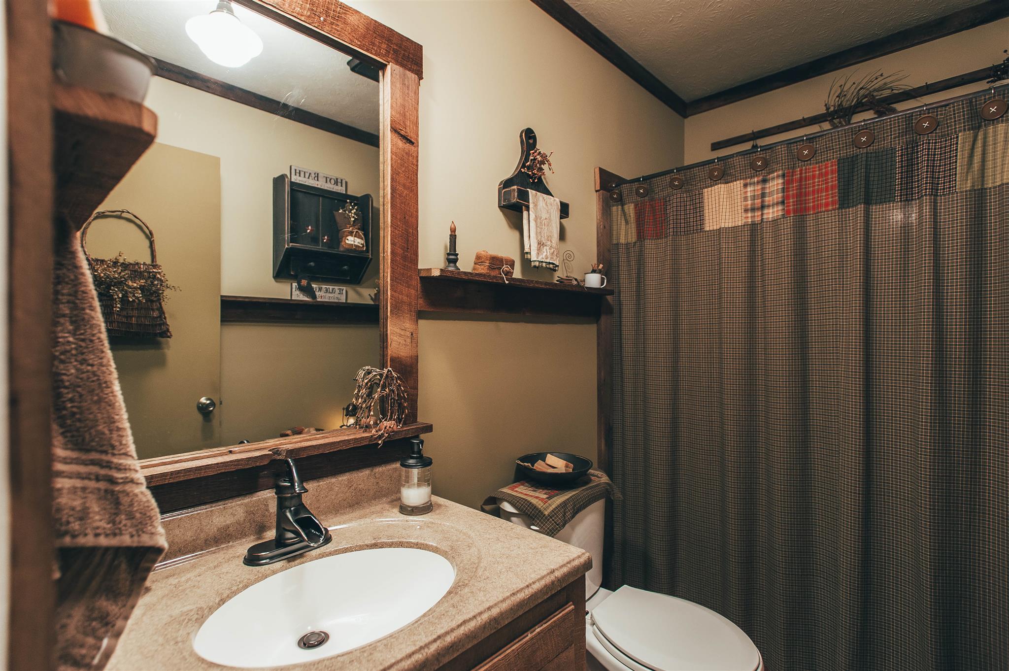 1253 Smith Thompson Road Bethpage, TN 37022 - Photo 6 of 19 a bathroom with a sink a toilet and mirror