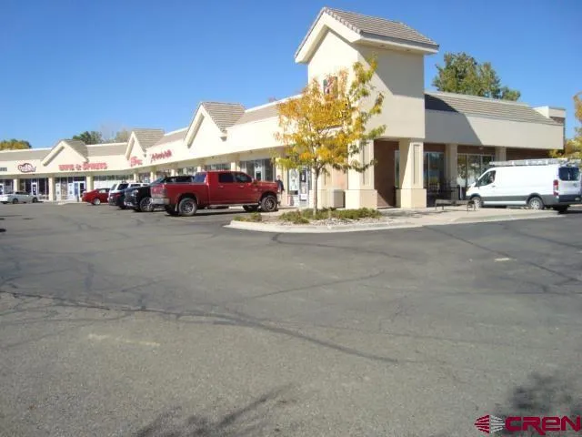 a view of a building with car parked