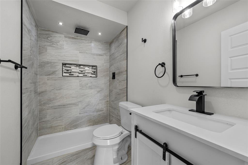 3530 Bluebird Street Bellmead, TX 76705 - Photo 14 of 24 a bathroom with a sink a toilet and shower