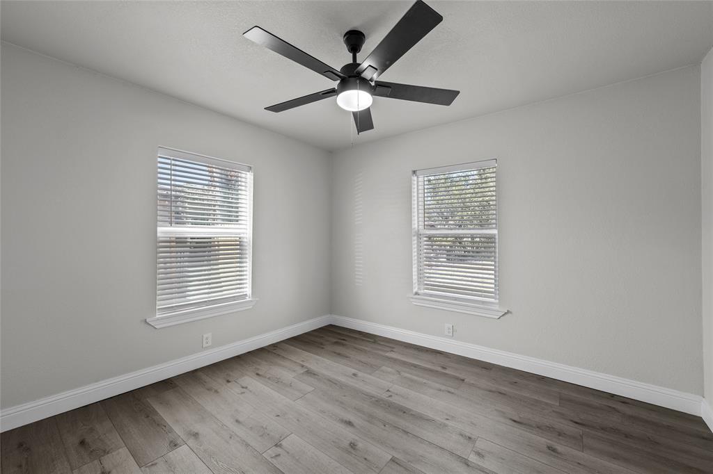 3530 Bluebird Street Bellmead, TX 76705 - Photo 17 of 24 a view of an empty room with wooden floor and a window