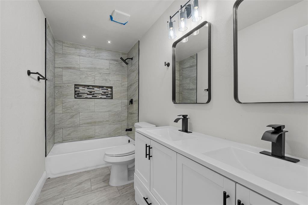 3530 Bluebird Street Bellmead, TX 76705 - Photo 18 of 24 a bathroom with a double vanity sink toilet and shower