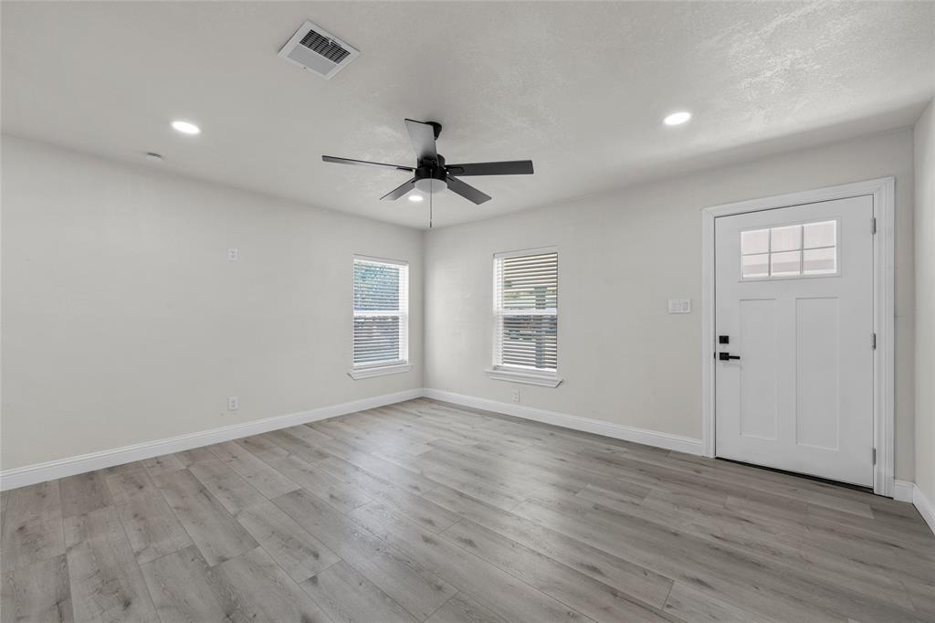 3530 Bluebird Street Bellmead, TX 76705 - Photo 6 of 24 wooden floor in an empty room with a window