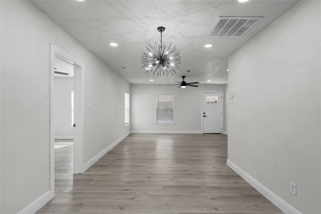 3530 Bluebird Street Bellmead, TX 76705 - Photo 7 of 24 wooden floor in an empty room with a window