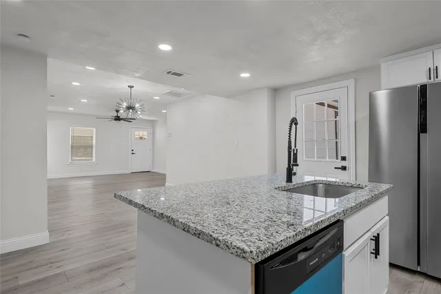 a kitchen with stainless steel appliances a refrigerator stove microwave and cabinets