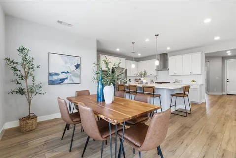 a view of a dining room with furniture and wooden floor